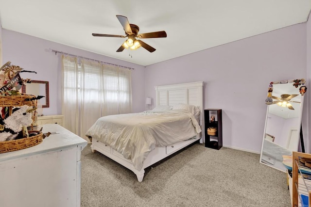 bedroom featuring light colored carpet, ceiling fan, and baseboards