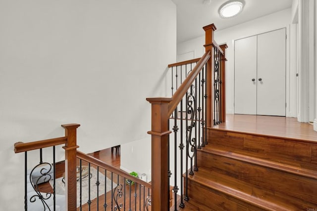 staircase with wood finished floors