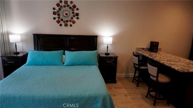 bedroom featuring light wood-type flooring and baseboards