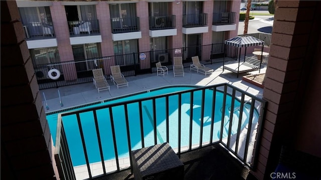 pool featuring a patio area and fence