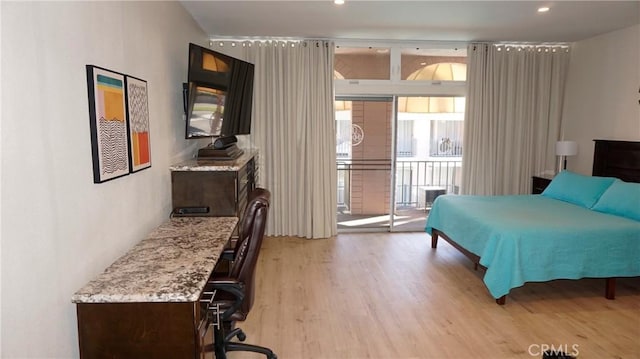 bedroom with access to outside, light wood-style flooring, and recessed lighting