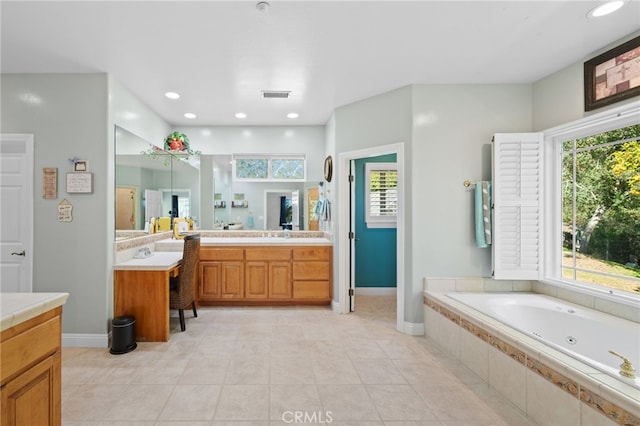 full bathroom featuring recessed lighting, vanity, visible vents, baseboards, and a bath