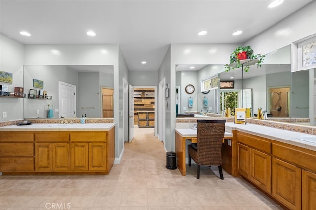 full bath with two vanities, a sink, and recessed lighting