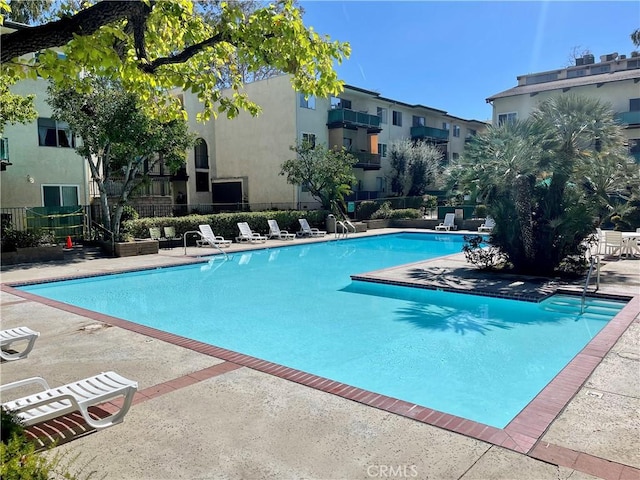 pool featuring a patio area and fence