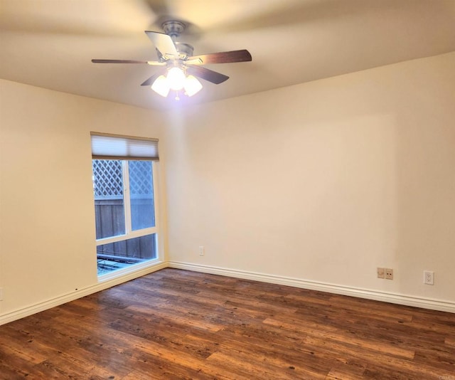 empty room featuring ceiling fan, baseboards, and wood finished floors