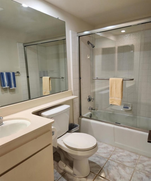 full bath featuring vanity, toilet, and bath / shower combo with glass door