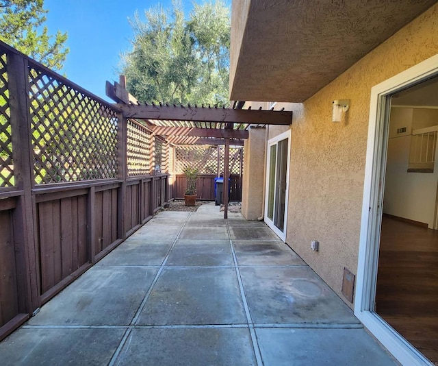 view of patio featuring fence and a pergola