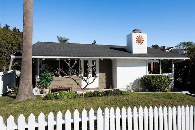 ranch-style home with a fenced front yard and a shingled roof