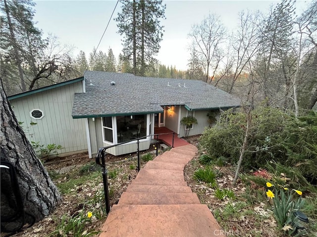 view of front of home featuring roof with shingles