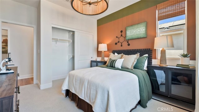 bedroom featuring a closet, carpet flooring, and baseboards