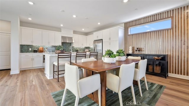 dining room with light wood-type flooring and recessed lighting