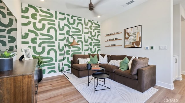 living area with recessed lighting, visible vents, ceiling fan, light wood-type flooring, and baseboards