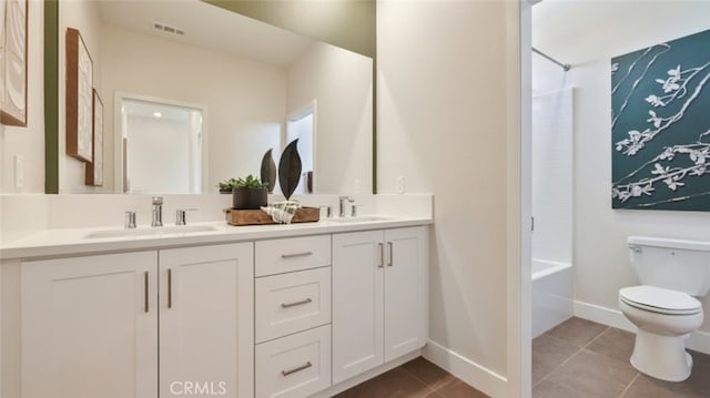 bathroom featuring double vanity, visible vents, toilet, tile patterned floors, and a sink