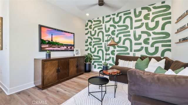 interior space featuring ceiling fan, recessed lighting, an accent wall, wood finished floors, and baseboards