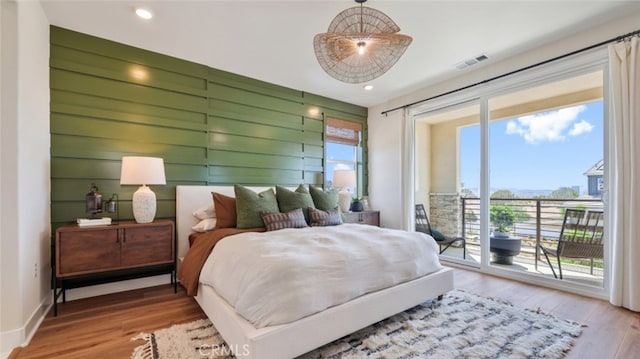 bedroom featuring access to exterior, visible vents, wood finished floors, and recessed lighting