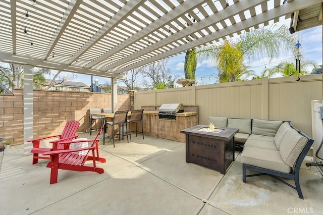 view of patio featuring an outdoor living space with a fire pit, an outdoor kitchen, area for grilling, outdoor dining space, and a fenced backyard