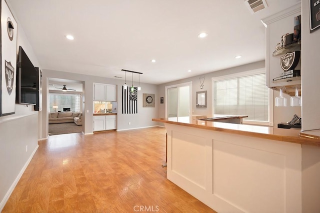 kitchen with plenty of natural light, recessed lighting, visible vents, and light wood-style floors