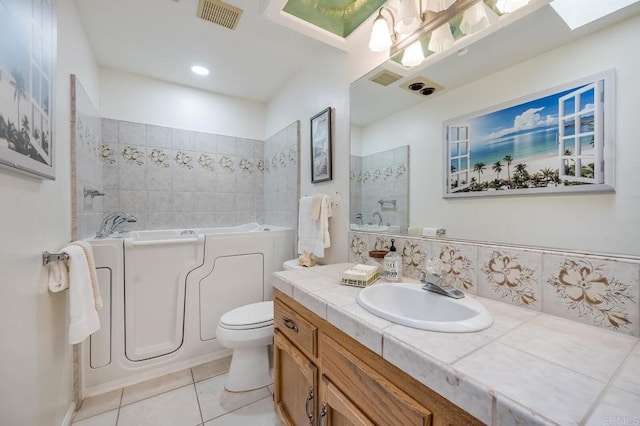 bathroom featuring visible vents, a garden tub, tile patterned flooring, walk in shower, and vanity