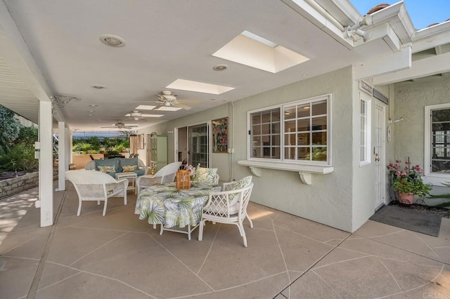 view of patio with an outdoor living space and a ceiling fan