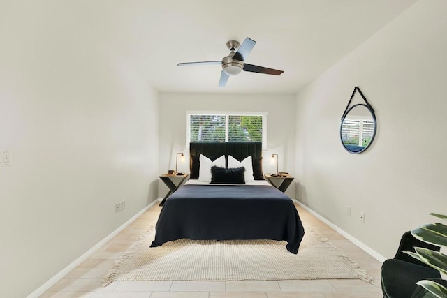 bedroom with a ceiling fan and baseboards