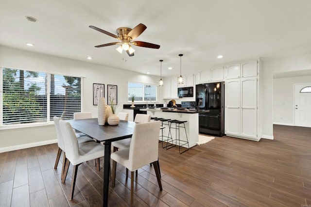 dining space featuring baseboards, dark wood-type flooring, a ceiling fan, and recessed lighting