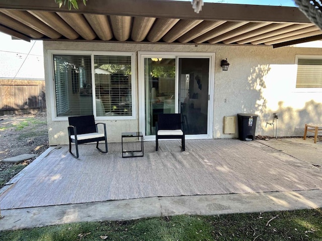 view of patio / terrace with a deck and fence