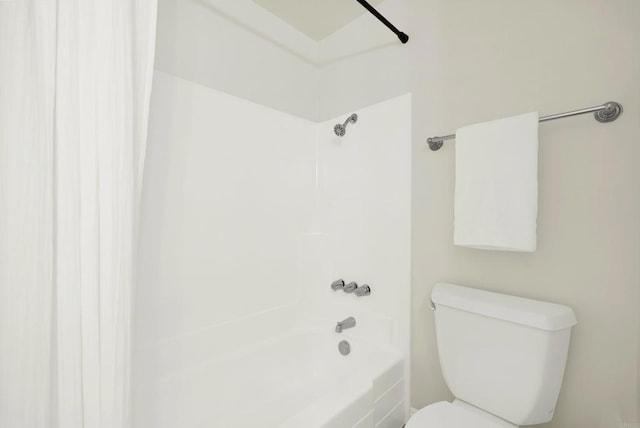 bathroom with bathing tub / shower combination and toilet