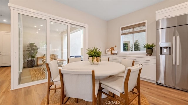 dining space featuring light wood-style floors