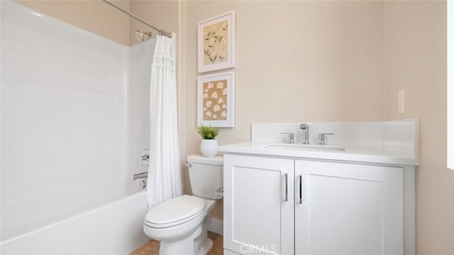 full bathroom featuring toilet, shower / tub combo with curtain, and vanity