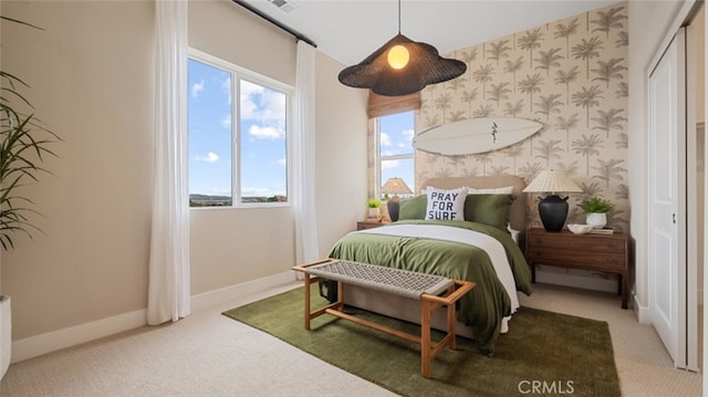 carpeted bedroom with baseboards and wallpapered walls