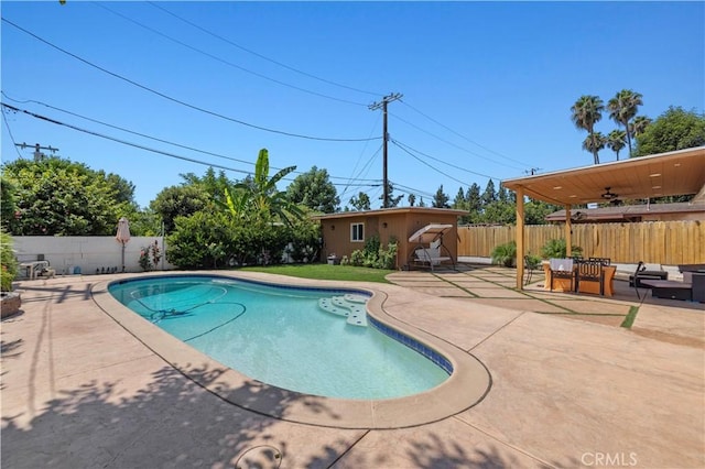 view of pool featuring a fenced in pool, an outbuilding, a patio, an outdoor hangout area, and a fenced backyard