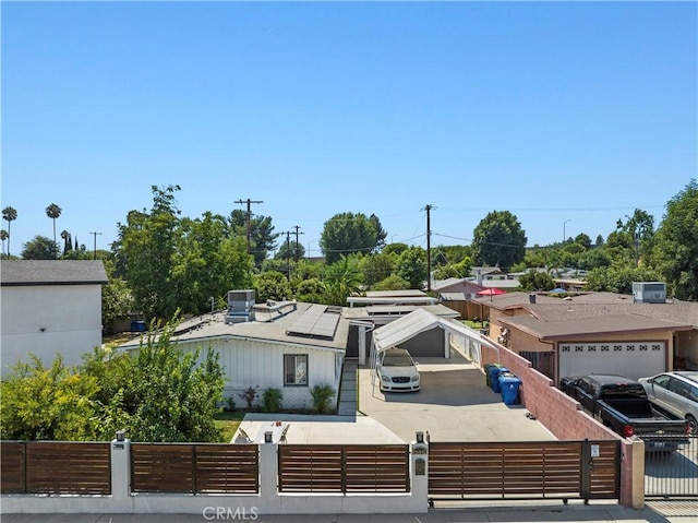 view of front facade with a fenced front yard and roof mounted solar panels