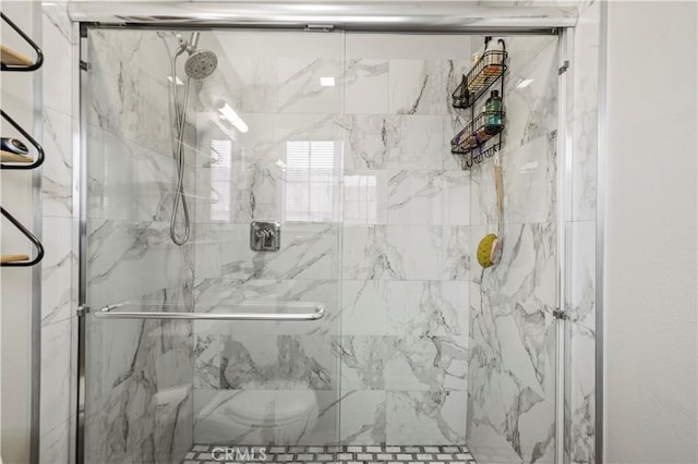 full bathroom with a marble finish shower