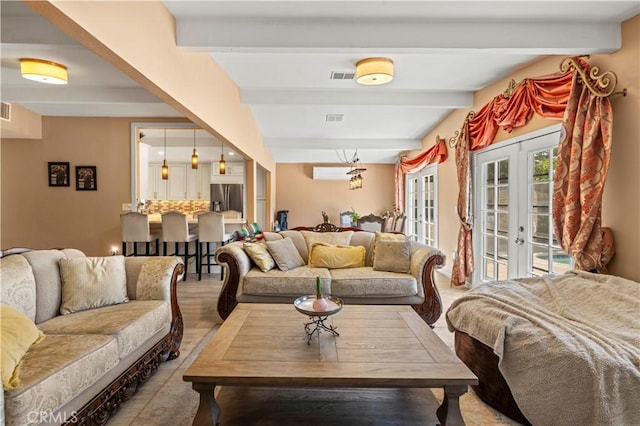 living room featuring french doors, visible vents, and beamed ceiling