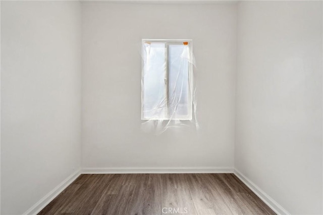 empty room with wood finished floors and baseboards