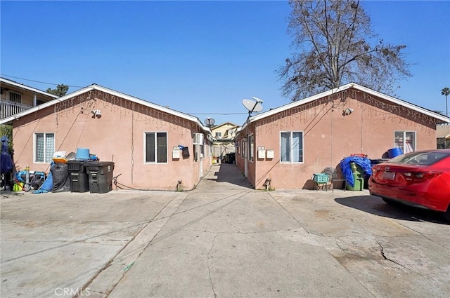 view of side of home featuring a patio area and stucco siding