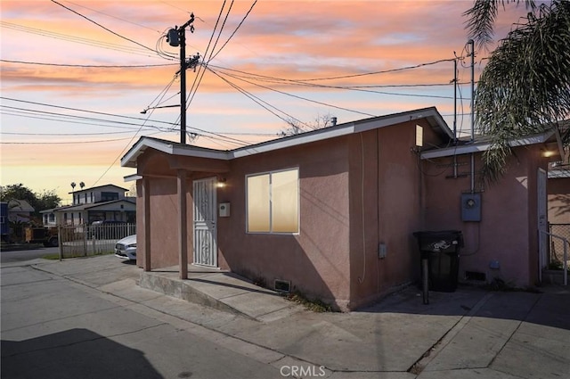 view of front of property with fence and stucco siding