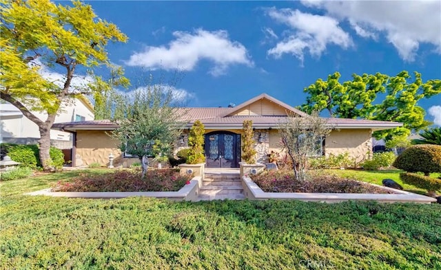 ranch-style house with french doors, a front lawn, and stucco siding