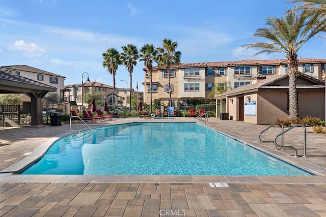 community pool featuring a patio area and fence