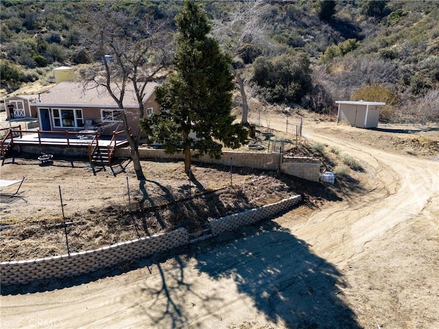 view of yard featuring a wooden deck and a garden