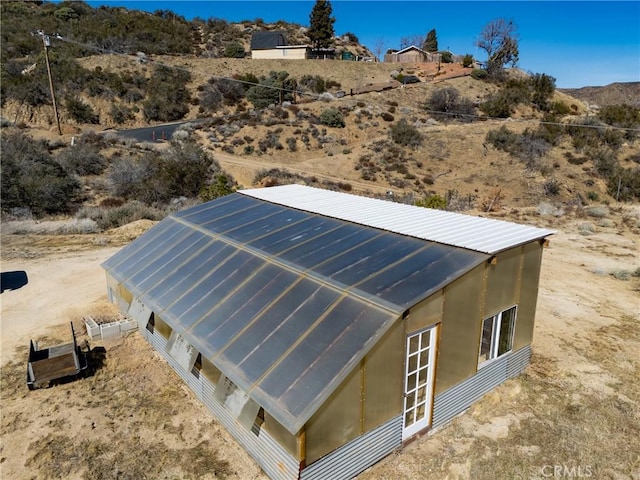 exterior space featuring metal roof and a desert view