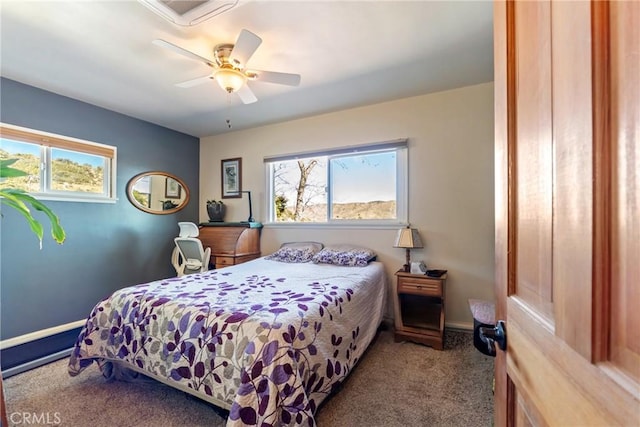 bedroom with ceiling fan, carpet floors, multiple windows, and baseboards