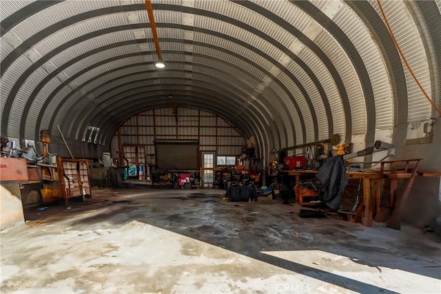 interior space featuring lofted ceiling and concrete floors