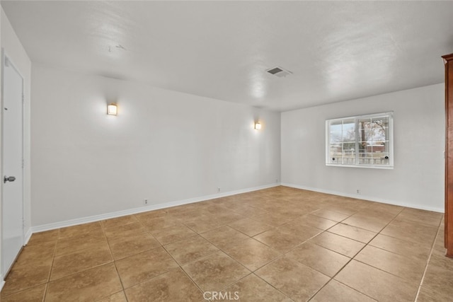 spare room featuring light tile patterned floors, baseboards, and visible vents