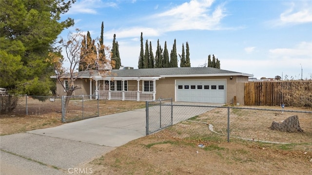 ranch-style home featuring a garage, concrete driveway, a fenced front yard, and stucco siding