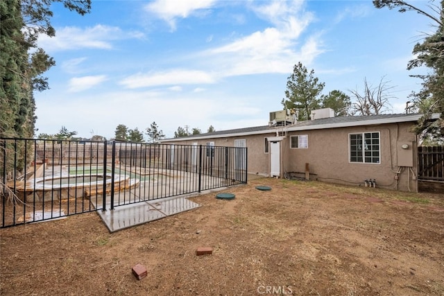 back of house with a fenced in pool, fence, a patio, and stucco siding