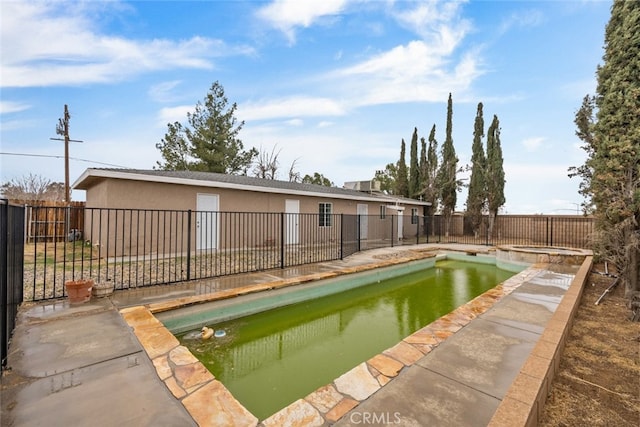 view of swimming pool with a patio area, a fenced backyard, and a pool with connected hot tub