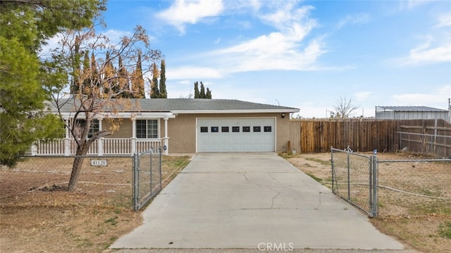 ranch-style home with an attached garage, fence, driveway, a gate, and stucco siding