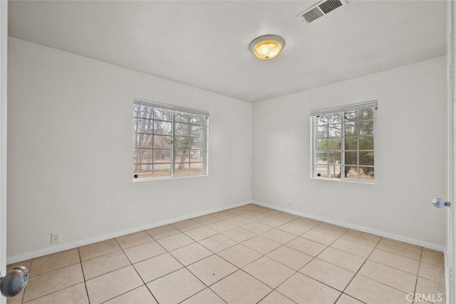 empty room with baseboards and visible vents