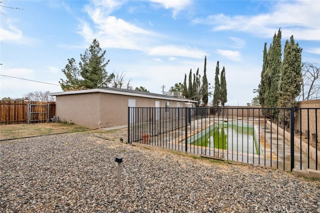 rear view of property with fence and stucco siding